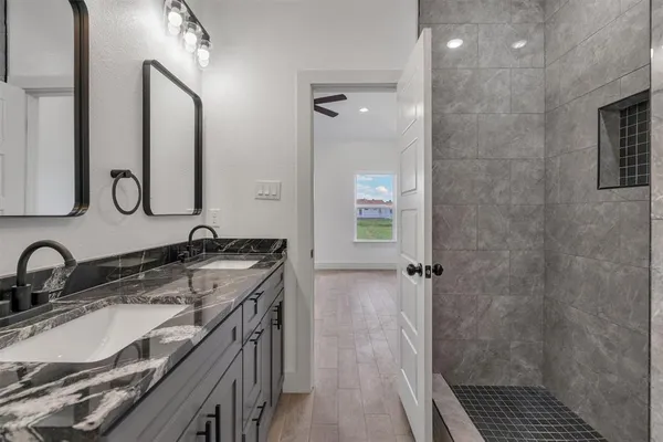 a bathroom with a sink double vanity and a mirror
