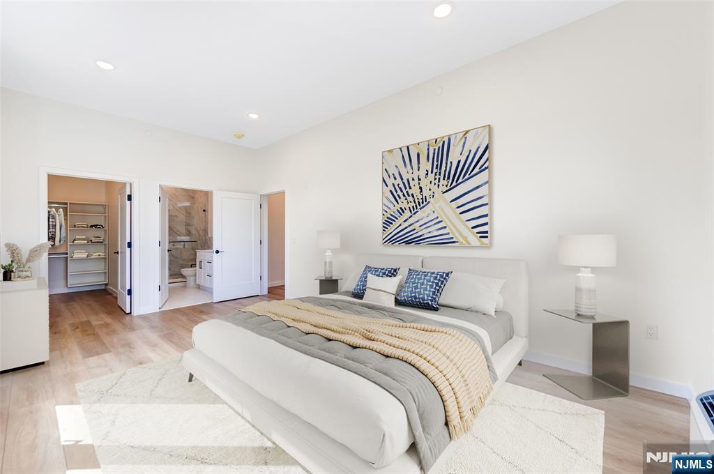 a bedroom with a large bed and a lamp