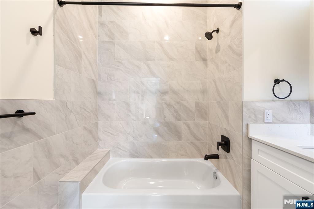 51 Queen Anne Road, Unit 405 Bogota, NJ 07603 - Photo 8 of 17 a bathroom with a white bath tub