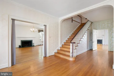 a view of entryway and hall with wooden floor