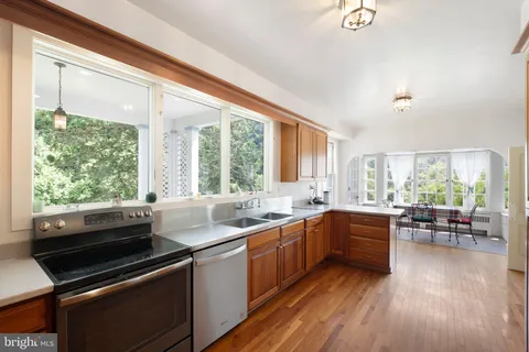 a kitchen with sink cabinets and wooden floor