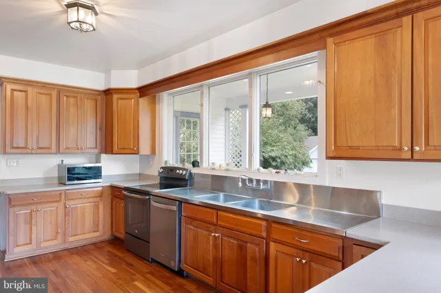 a kitchen with a sink window and cabinets
