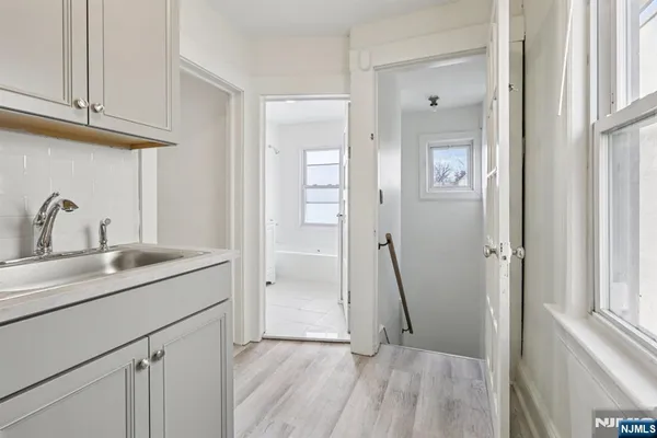 a view of a kitchen sink and a wooden floor