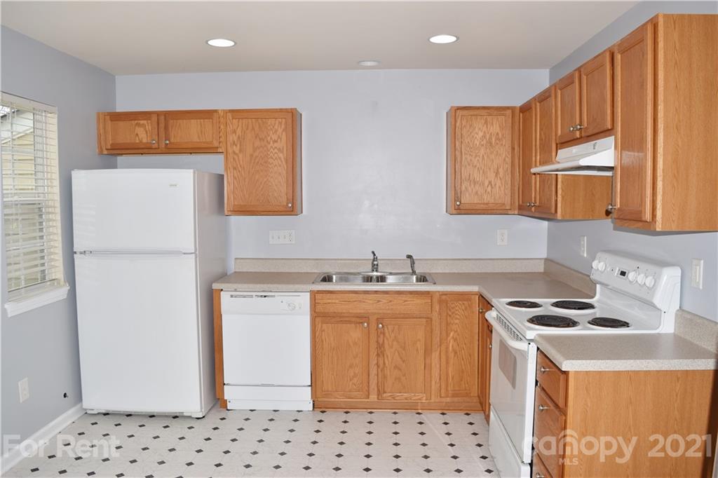 138 Limerick Road Mooresville, NC 28115 - Photo 13 of 33 a kitchen with a sink a stove a refrigerator and cabinets