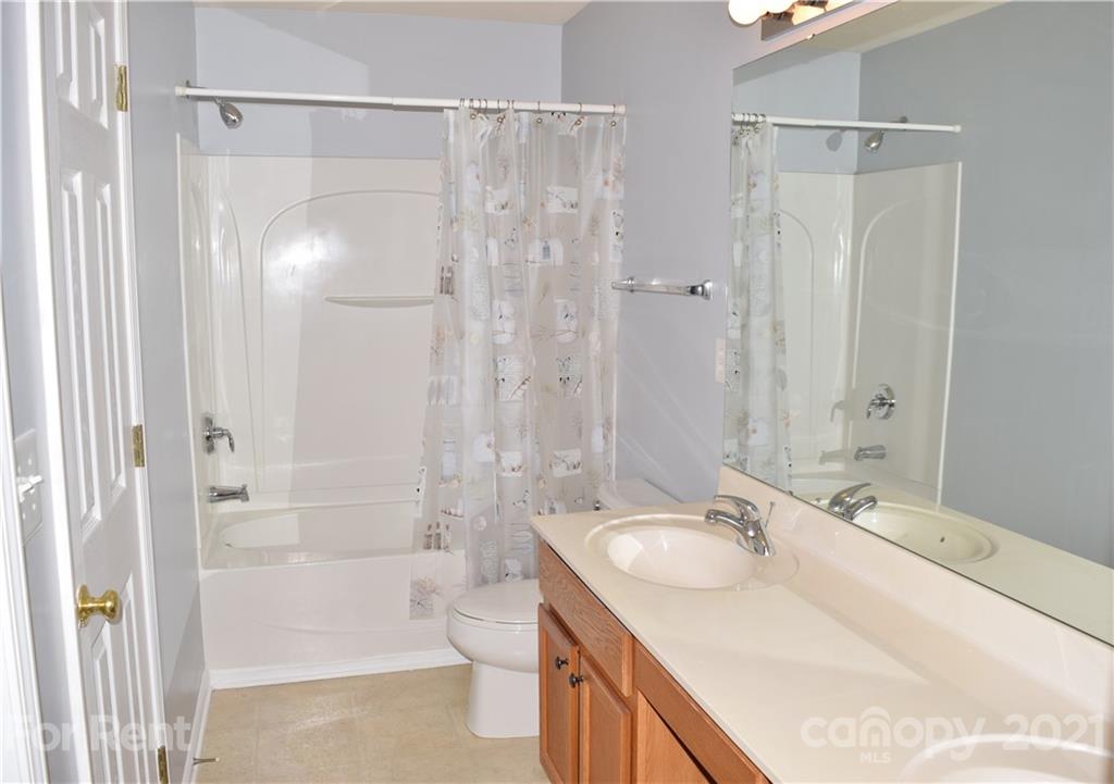 138 Limerick Road Mooresville, NC 28115 - Photo 27 of 33 a bathroom with a granite countertop sink toilet and shower