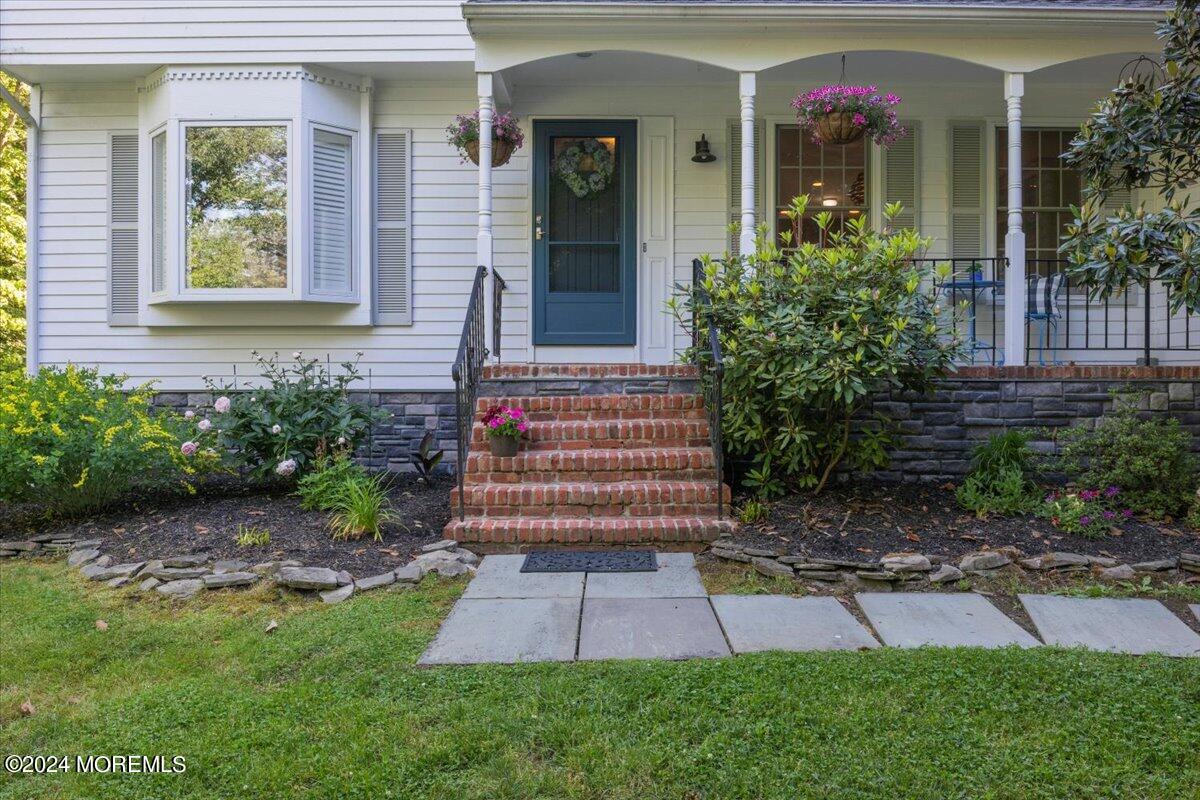 676 Locust Point Road Atlantic Highlands, NJ 07716 - Photo 11 of 56 a front view of a house with garden