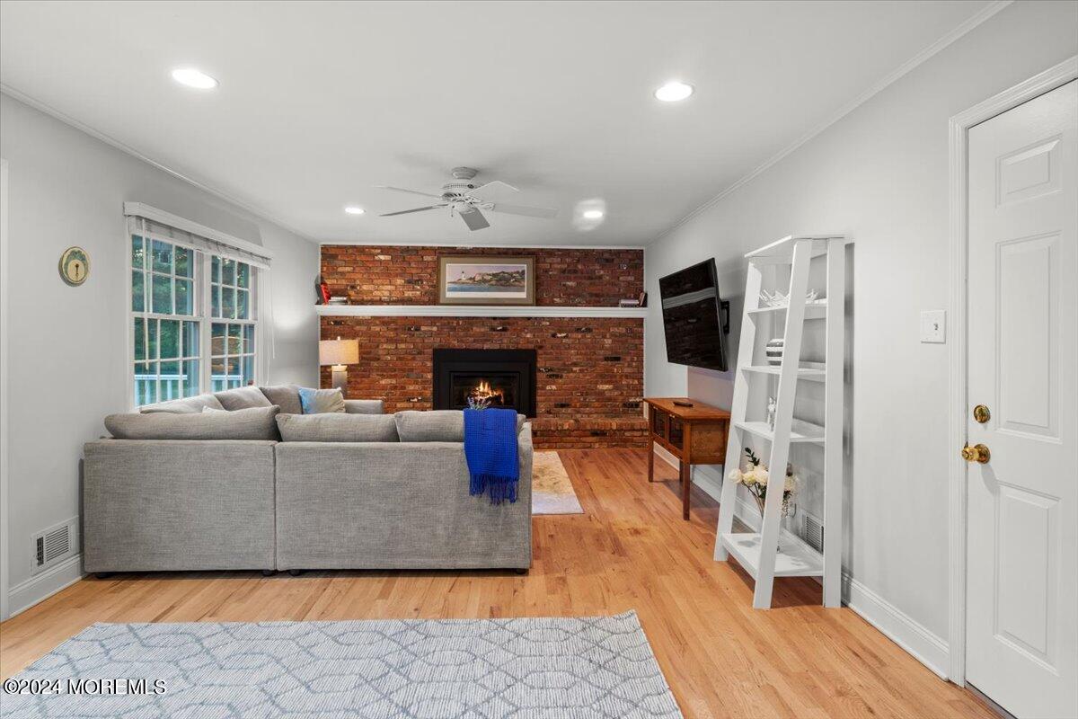 676 Locust Point Road Atlantic Highlands, NJ 07716 - Photo 18 of 56 a living room with furniture flat screen tv and a fireplace