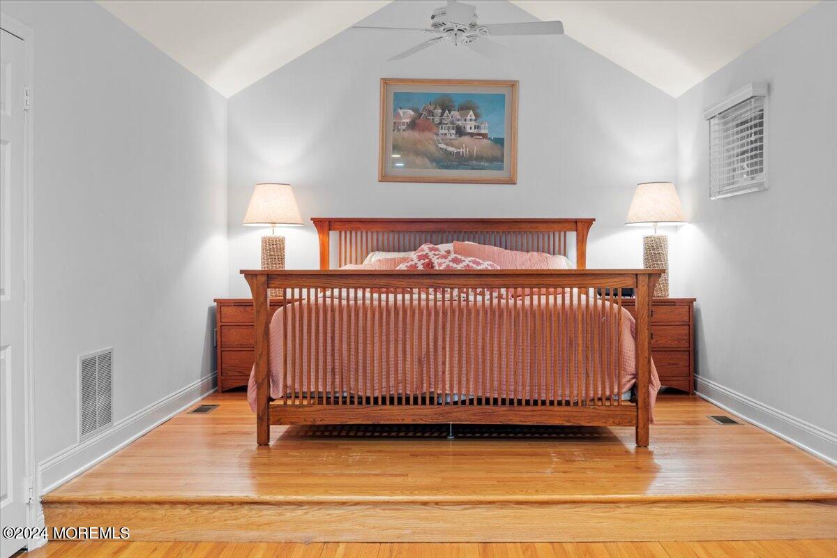 676 Locust Point Road Atlantic Highlands, NJ 07716 - Photo 19 of 56 a bedroom with a bed and a night stand