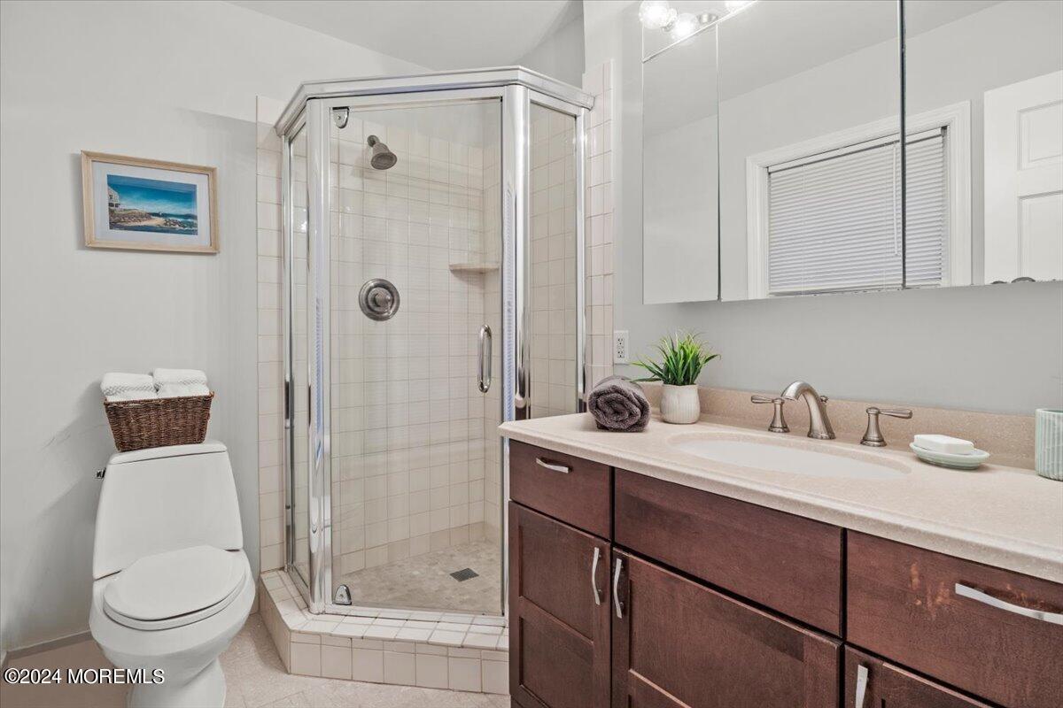 676 Locust Point Road Atlantic Highlands, NJ 07716 - Photo 22 of 56 a bathroom with a granite countertop sink a toilet and shower