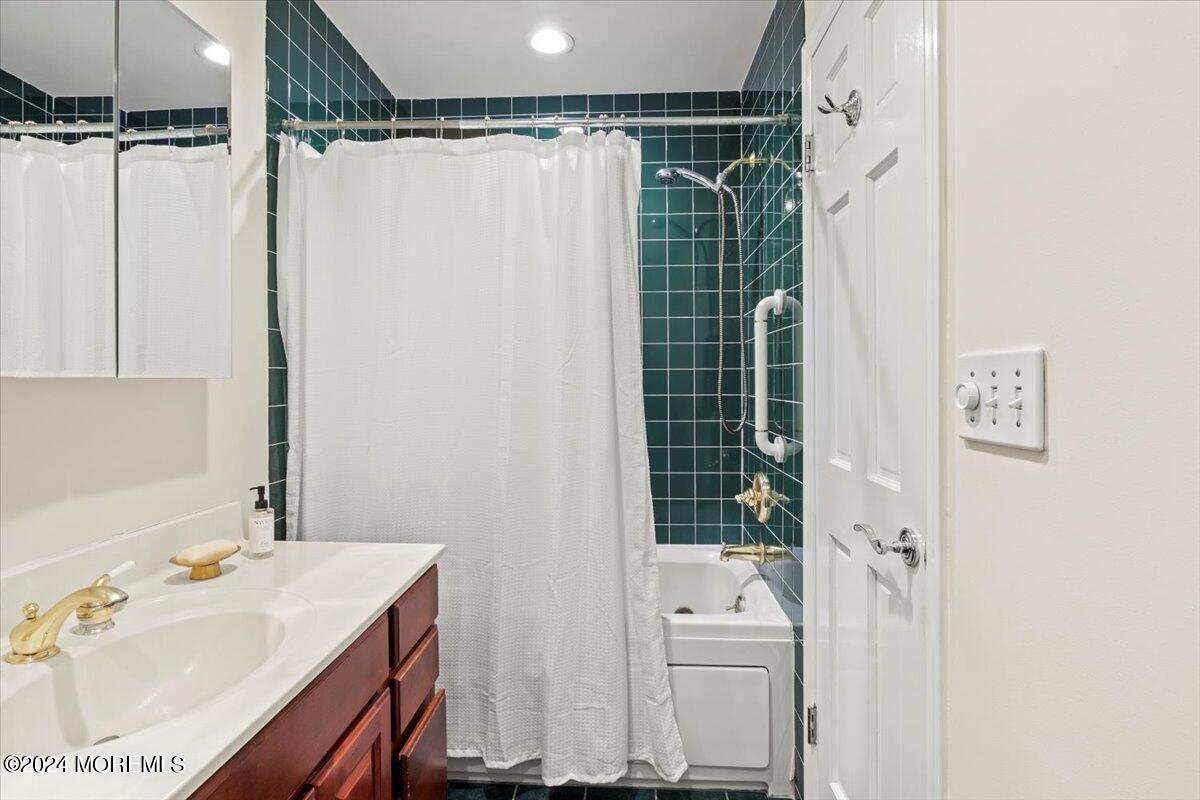 676 Locust Point Road Atlantic Highlands, NJ 07716 - Photo 26 of 56 a bathroom with a sink mirror and shower