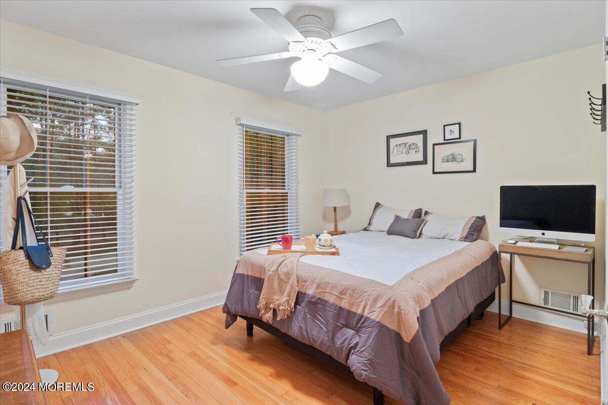 676 Locust Point Road Atlantic Highlands, NJ 07716 - Photo 28 of 56 a bedroom with a bed and a flat screen tv