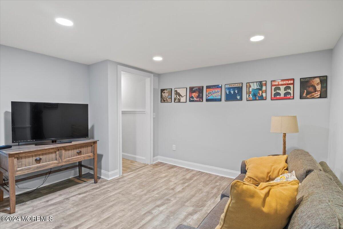676 Locust Point Road Atlantic Highlands, NJ 07716 - Photo 32 of 56 a living room with furniture and a flat screen tv