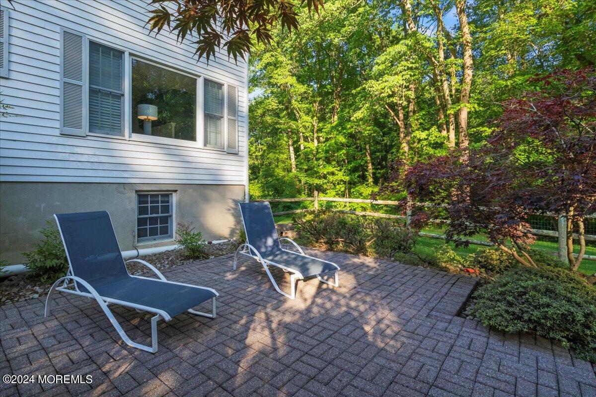676 Locust Point Road Atlantic Highlands, NJ 07716 - Photo 39 of 56 a view of a chair and table in backyard of the house