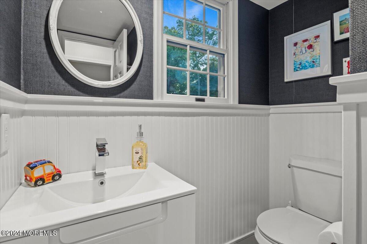 676 Locust Point Road Atlantic Highlands, NJ 07716 - Photo 4 of 56 a bathroom with a toilet a sink and a mirror