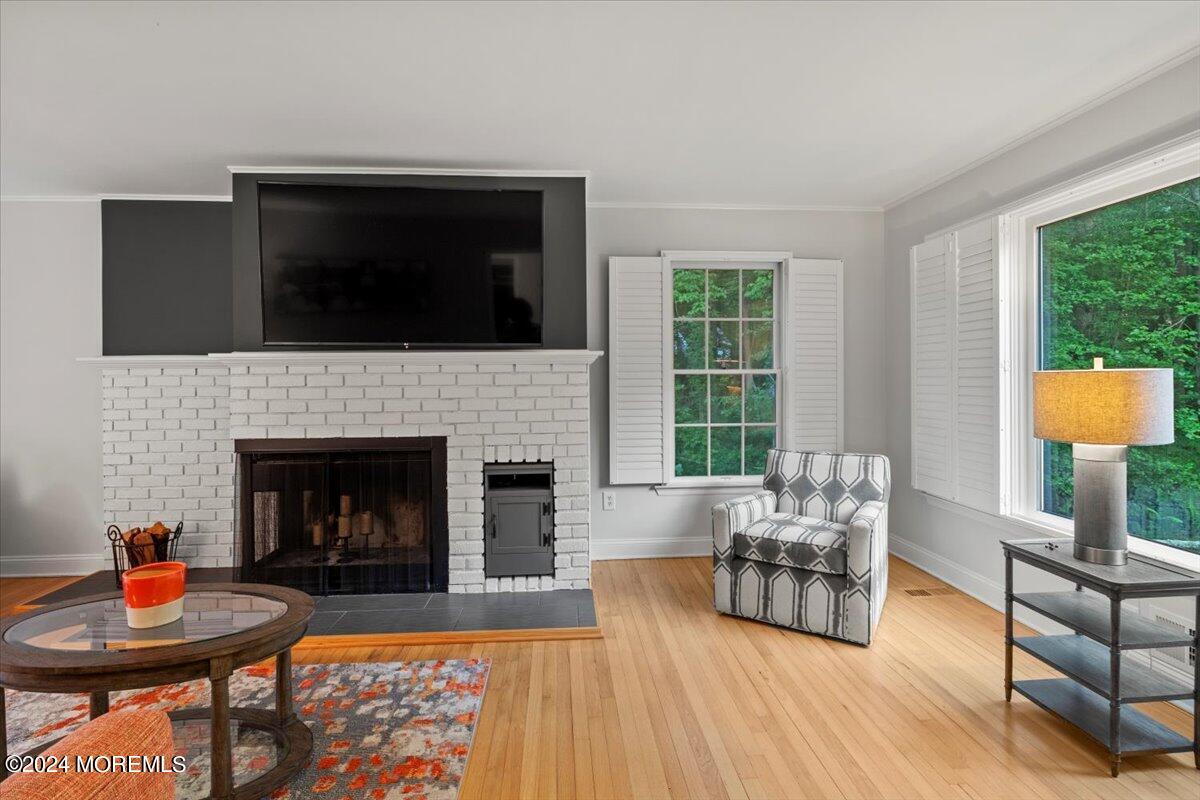 676 Locust Point Road Atlantic Highlands, NJ 07716 - Photo 5 of 56 a living room with furniture and a fireplace