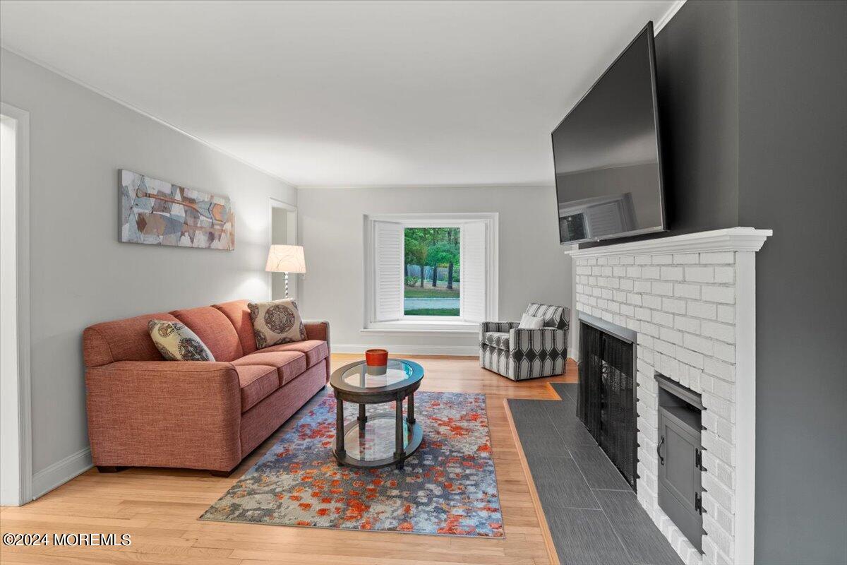 676 Locust Point Road Atlantic Highlands, NJ 07716 - Photo 7 of 56 a living room with furniture and a fireplace