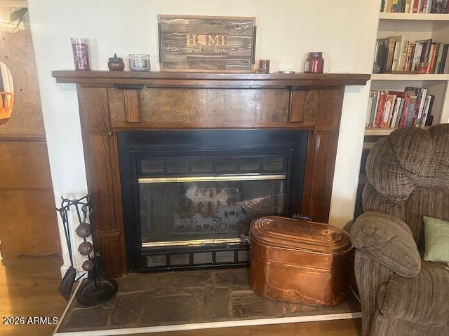 7258 South Lariat Road Hereford, AZ 85615 - Photo 5 of 37 a living room with furniture a fireplace and a book shelf