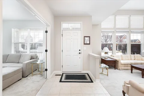 a living room with furniture a rug and white walls