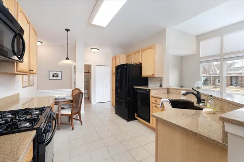 a kitchen with a refrigerator and a stove top oven