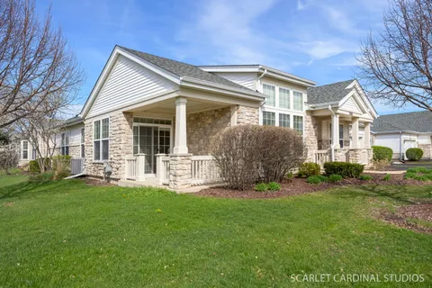 a front view of a house with a yard and porch