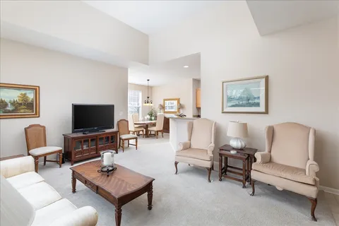 a living room with furniture a rug and a flat screen tv
