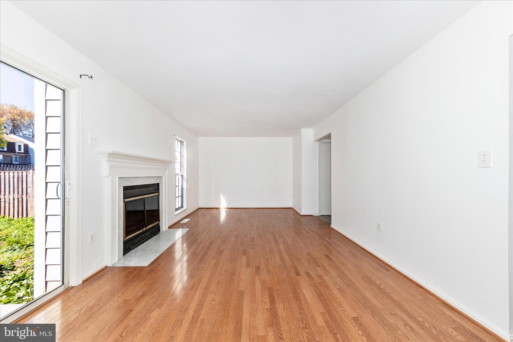13303 Country Ridge Drive Germantown, MD 20874 - Photo 12 of 45 a view of an empty room with wooden floor fireplace and a window