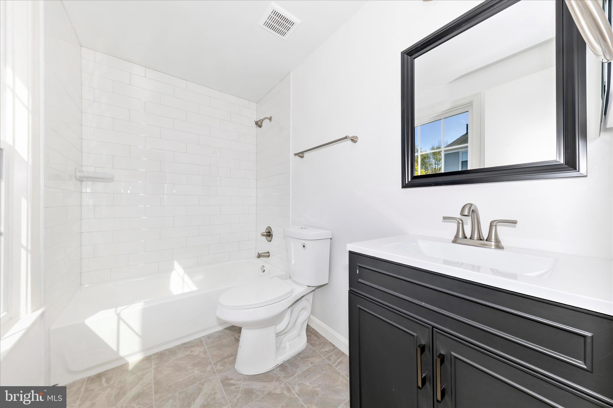 13303 Country Ridge Drive Germantown, MD 20874 - Photo 22 of 45 a bathroom with a granite countertop sink a toilet and a mirror
