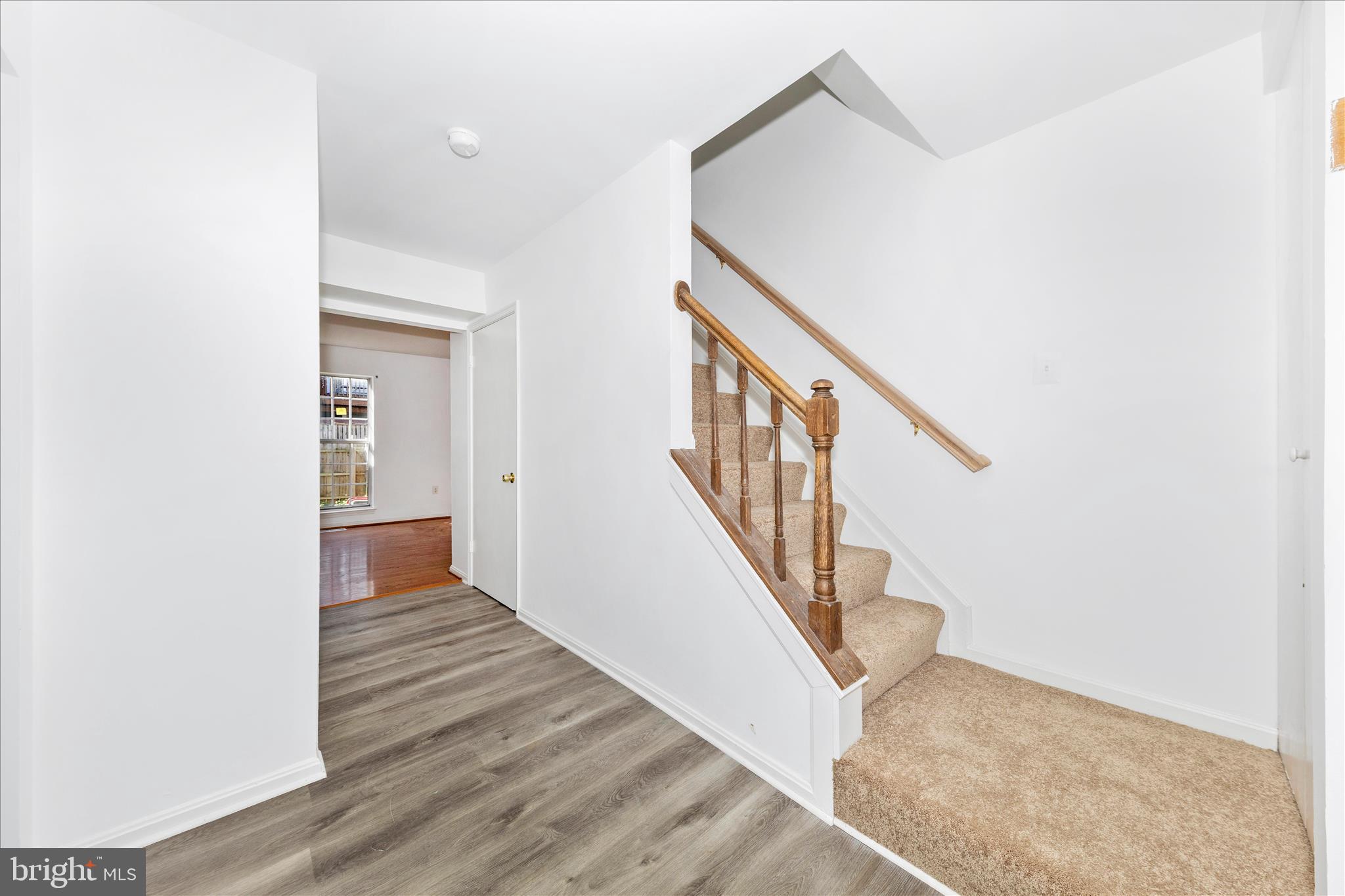 13303 Country Ridge Drive Germantown, MD 20874 - Photo 3 of 45 a view of a hallway with wooden floor and staircase