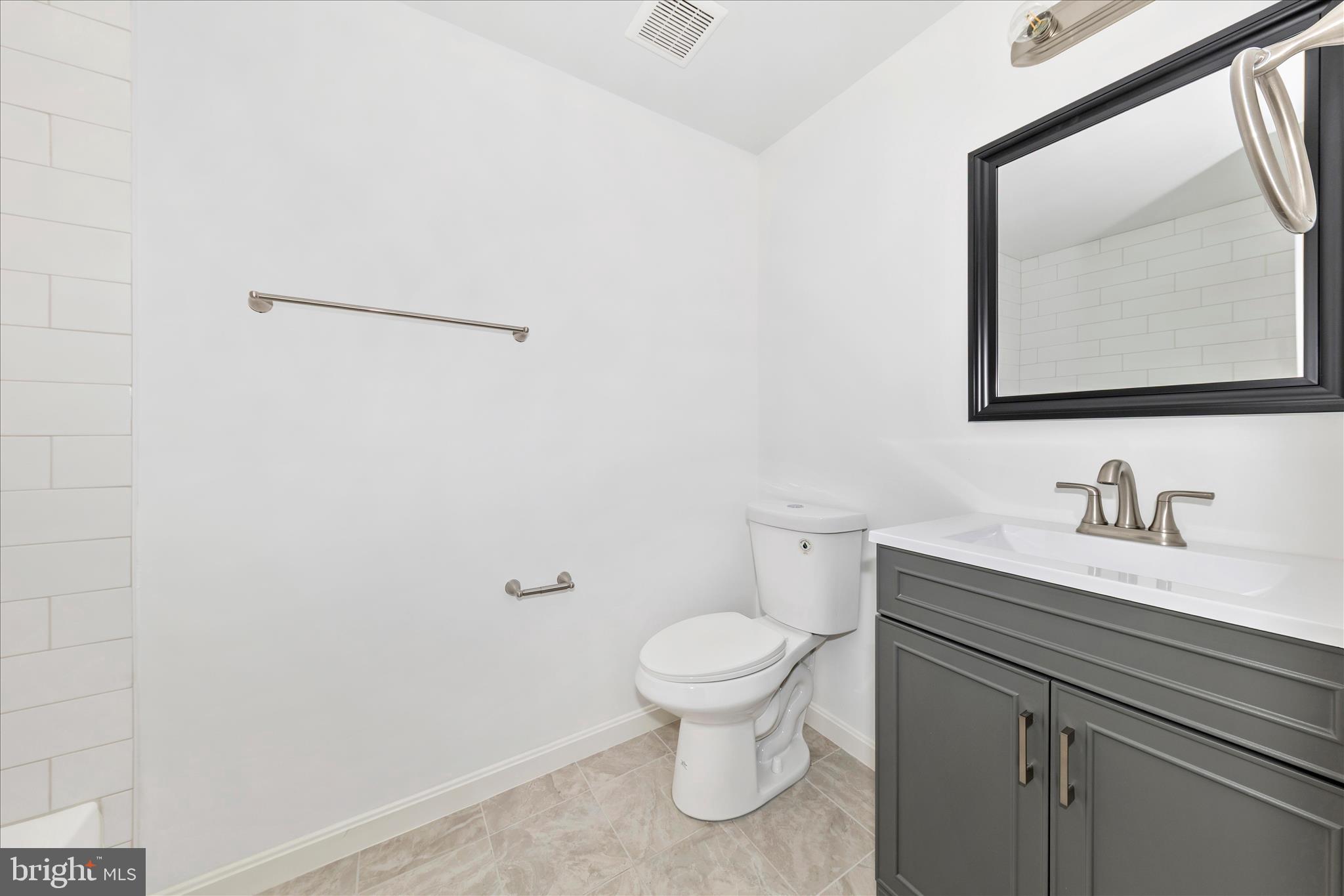 13303 Country Ridge Drive Germantown, MD 20874 - Photo 32 of 45 a bathroom with a granite countertop sink mirror vanity and toilet