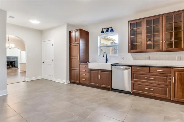 a view of kitchen with stainless steel appliances granite countertop a stove and a sink