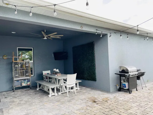 a dining room with furniture and a window