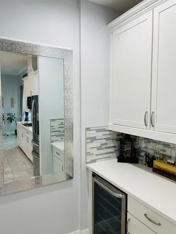 a kitchen with stainless steel appliances a refrigerator and cabinets