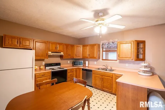 a kitchen with a sink appliances and cabinets