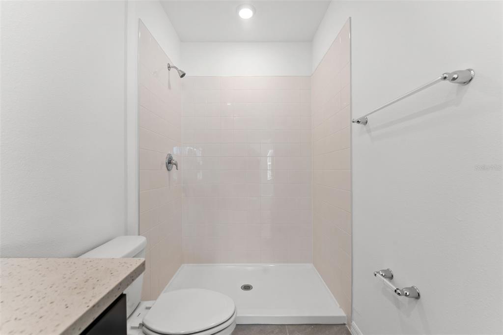 31336 Paper Birch Street Wesley Chapel, FL 33545 - Photo 15 of 38 a bathroom with a granite countertop sink toilet and shower