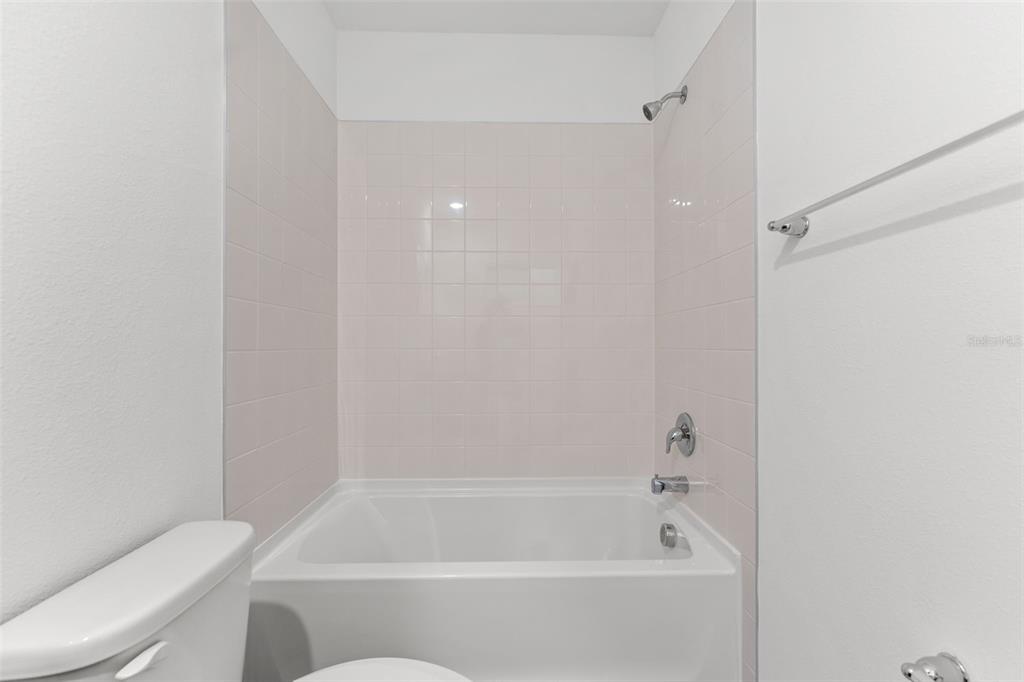 31336 Paper Birch Street Wesley Chapel, FL 33545 - Photo 25 of 38 a bathroom with a bathtub and toilet