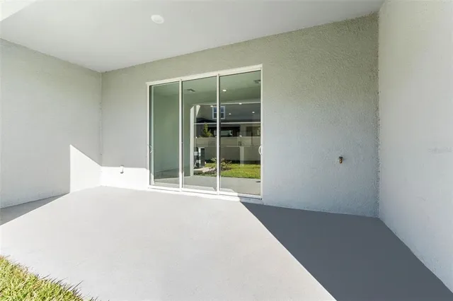 a view of an house with backyard and a tree