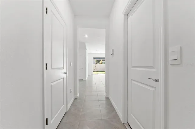 a view of a hallway with wooden shelves