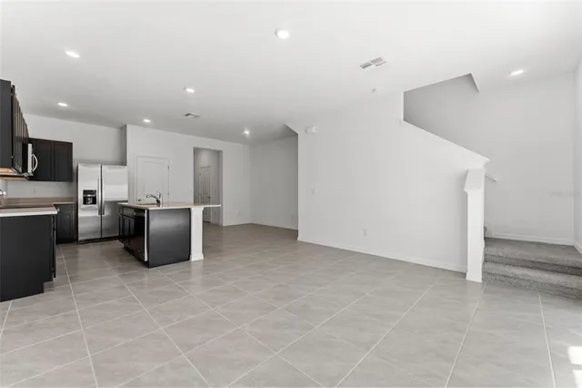 a kitchen with stainless steel appliances a refrigerator and a stove top oven