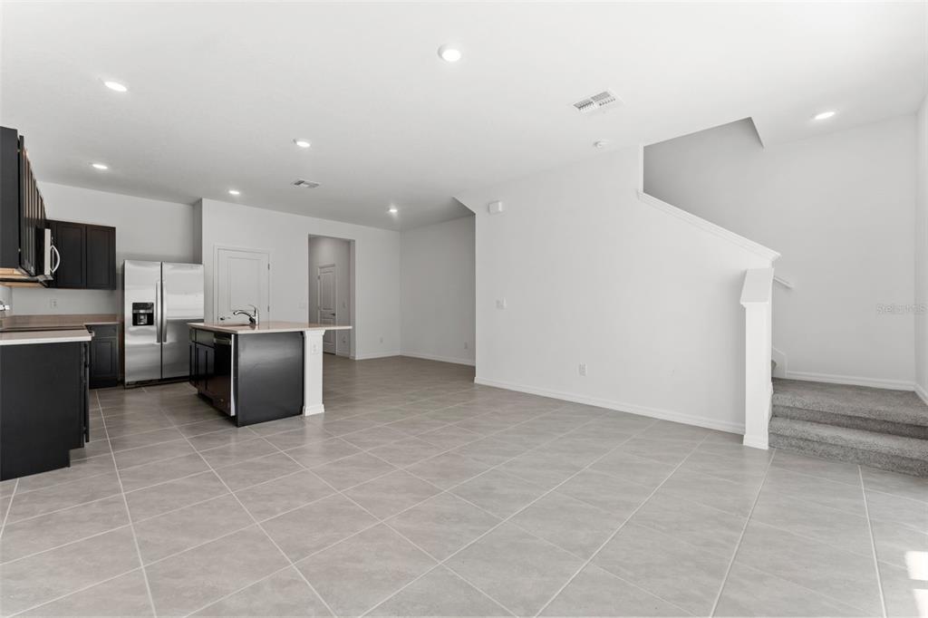 31336 Paper Birch Street Wesley Chapel, FL 33545 - Photo 8 of 38 a kitchen with stainless steel appliances a refrigerator and a stove top oven