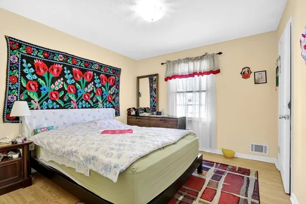 a bedroom with a bed and a dresser