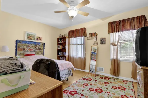 a bedroom with a bed and a flat screen tv