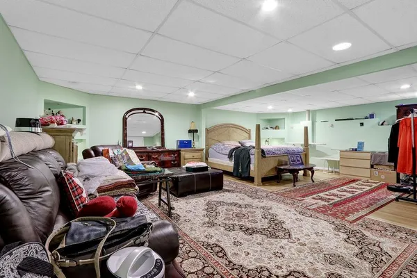 a living room with furniture a rug and a window