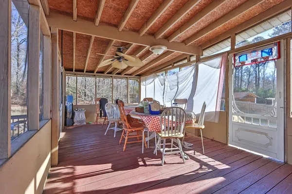 a view of a dining room with furniture wooden floor and windows
