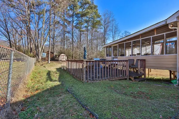 a view of a house with backyard and a tree