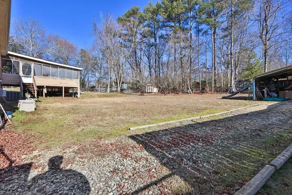 a view of a yard with a house in the background