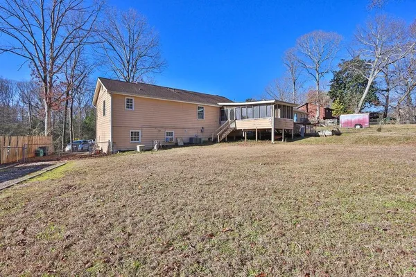 a view of a house with a yard covered in snow