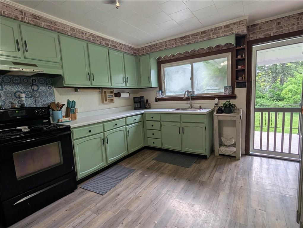 205 Woods Road Ligonier, PA 15658 - Photo 3 of 32 a kitchen with a sink and wooden cabinets
