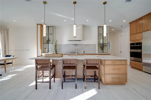 a kitchen with a potted plant on the counter and cabinets