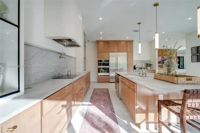 a kitchen with cabinets and stainless steel appliances