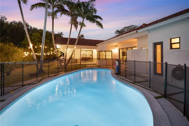 a kitchen with sink refrigerator and large window
